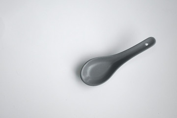 grey color chinese spoon made of ceramics，isolated in white background