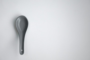 grey color chinese spoon made of ceramics，isolated in white background