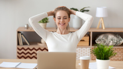 Woman relaxing after finished computer work, looking at screen