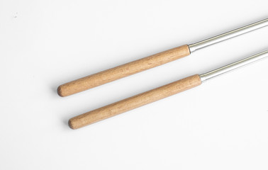 wood and metal chopsticks isolated in white background, looking fancy