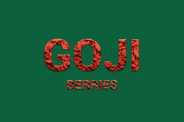 Red Goji berries texture text on green background. Typography of organic Super foods. Vegan, Vegetarian, Super food and detox food.