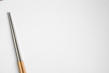 wood and metal chopsticks isolated in white background, looking fancy