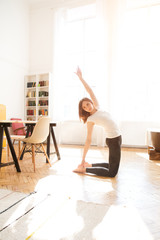 Woman stretching in room at home. Healthy and sport lifestyle. Fitness sport girl  doing yoga fitness exercise.