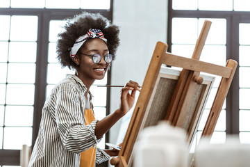 Excited talented art student working on her exam work
