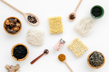 Chinese and Japanese food cooking with ginger, spices and noodles on white background top view geometric pattern