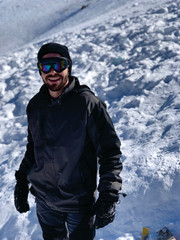 Fototapeta na wymiar man with jacket and glasses in the snow - valle nevado - Chile