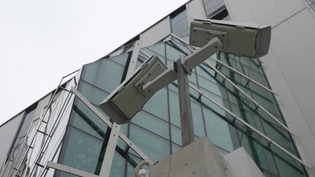 Outdoor Video surveillance and security cameras monitoring in front of a modern business building. Outdoor CCTV system for commercial building footage