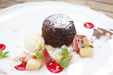 Chocolate lava cake, icecream and strawberry afternoon tea dessert in white plate