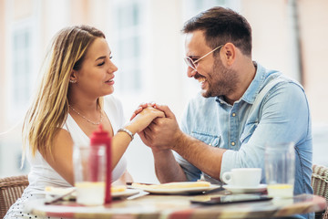 Couple eating pizza snack outdoors.They are sharing pizza and eating.