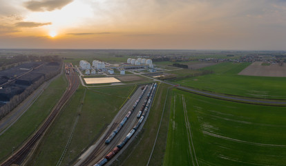 Aerial view on refineries oil big tanks and train transfering station.