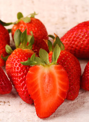 Healthy Heap of fresh strawberries on white wooden background.