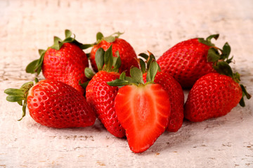 Healthy Heap of fresh strawberries on white wooden background.