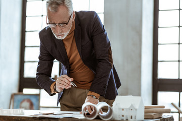 Interior designer wearing glasses checking the documents