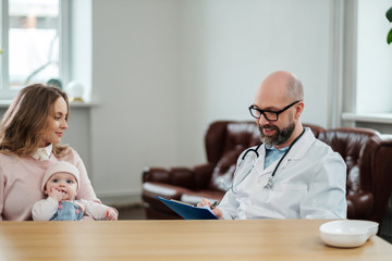 Mother with baby visiting pediatrician