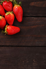 Healthy Heap of fresh strawberries on black wooden background., selective focus