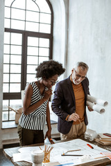 Boss of interior design company helping his employee with task