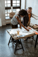 Interior designer explaining some difficult moments to his trainee