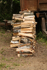 stack chopped birch firewood pile high in profile on dry ground background stocking firewood winter fireplace