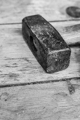 big hammer sledgehammer head tool on background blackboard close-up toned design