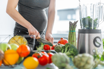Pregnant woman cooking healthy food