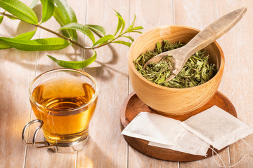 Tea with lemon verbena - Aloysia citrodora. Wood background
