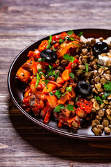 Rice with lentils and vegetables on wooden table