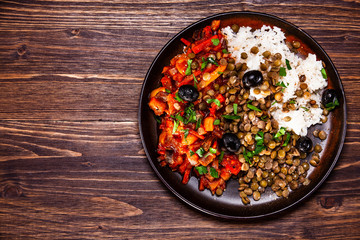 Rice with lentils and vegetables on wooden table