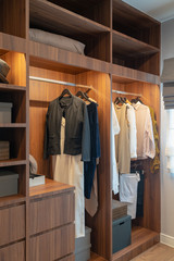 modern closet with clothes hanging