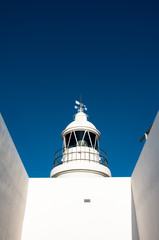 Albir Lighthouse at L'Alfàs del Pi. White coast, Spain.