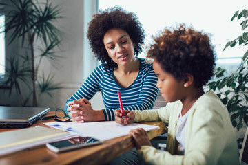 Mother and daughter doing homework learning to calculate