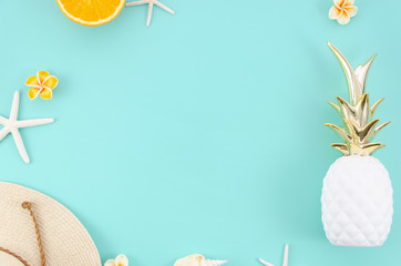 Summer flat lay frame with oranges, hat and pineapple. Top view