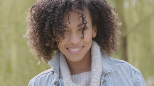 Spring or sunny Autumn outdoor portrait of beautiful mixed race young woman