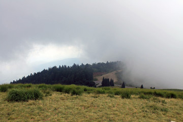 Fototapeta na wymiar Low clouds on the mountain Mottarone, Italy