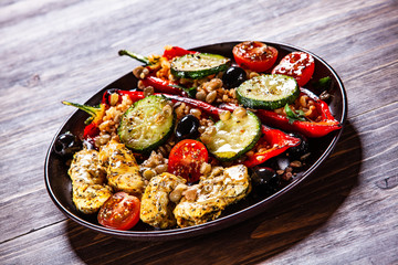 Pepper stuffed with groats and vegetables and grilled chicken strips