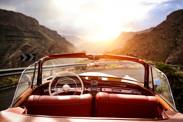 Summer car on road and sunset time in mountains. 