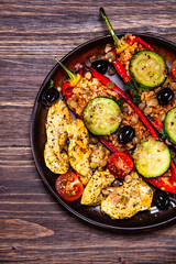 Pepper stuffed with groats and vegetables and grilled chicken strips