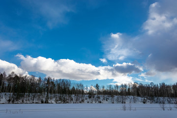 Beautiful bright clouds on the blue March sky in the spring day.