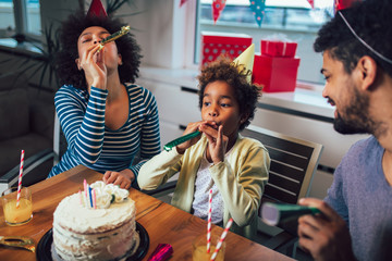 Happy family celebrating a birthday together at home