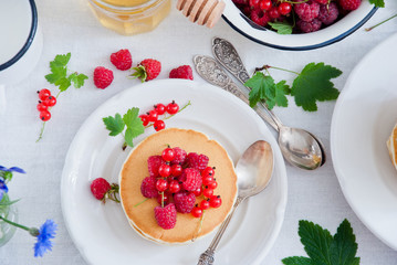 Breakfast Pancakes with fresh red berries and honey