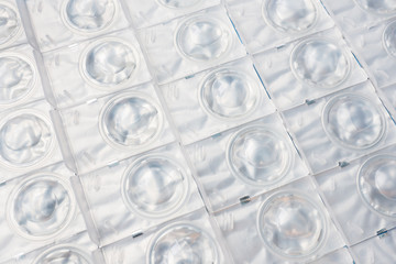 Packed contact lenses in disposable plastic containers. Close up. Selective focus.