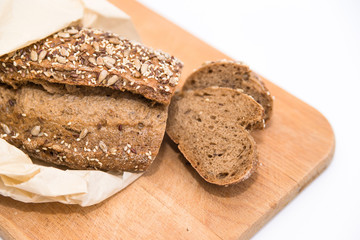 dark rye bread with grains and seeds on a wooden board