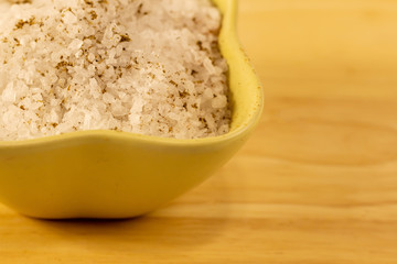 salt large crystals pile ceramic bowl piece on a wooden beige background natural traditional seasoning