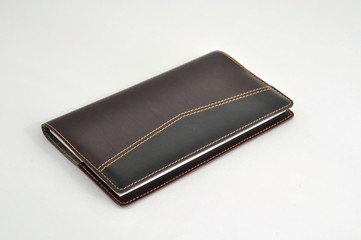 notebook in black brown leather binding with gold thread in the line