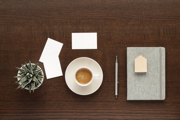 Obraz na płótnie Canvas cup of coffee and business card on wooden table top view with copy space for your text. flat lay. 