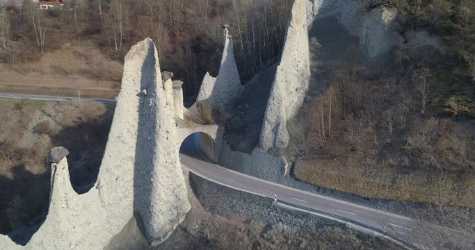 Car pass under Euseigne Pyramides - Aerial 4K
