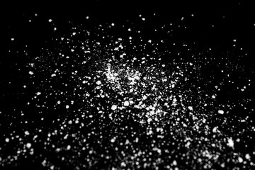 white crystalline powder on a black background. sugar dust 