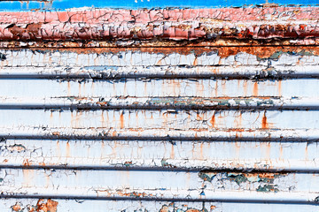 Old cracked rusty peeled colorful paint background texture close-up