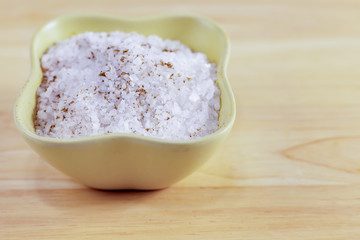 salt mini crystals white mineral seasoning traditional close-up on a wood background