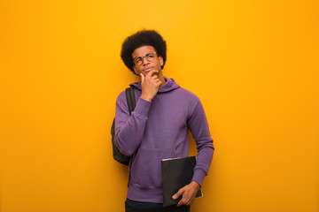 Young african american student man doubting and confused