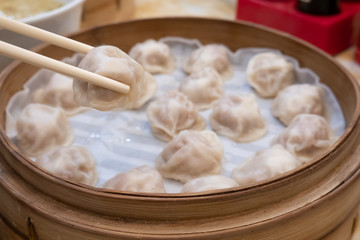 Xiao long bao soup dumpling buns with chopsticks in restaurant (Traditional Chinese food) in Taipei Taiwan